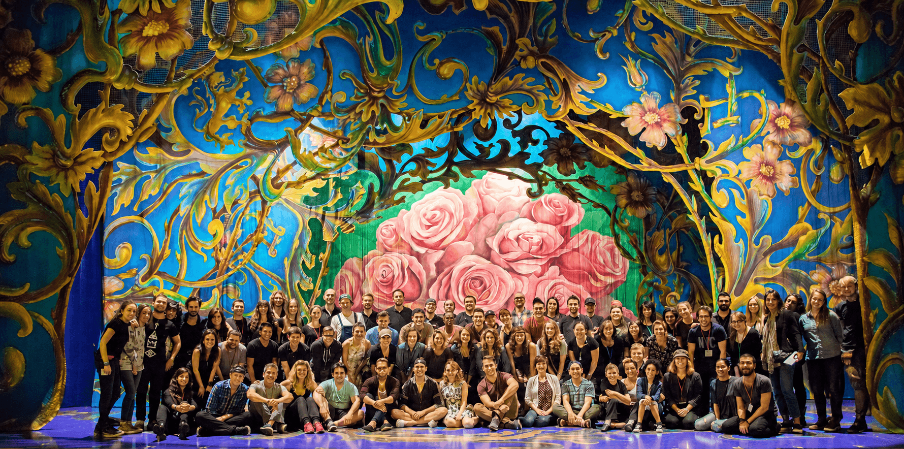 Large theater cast and crew on stage