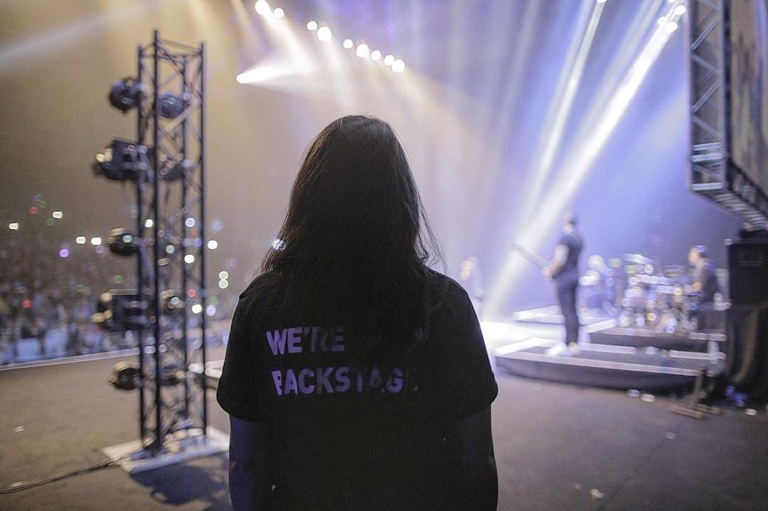 Black Howl backstage crew member watching a live show